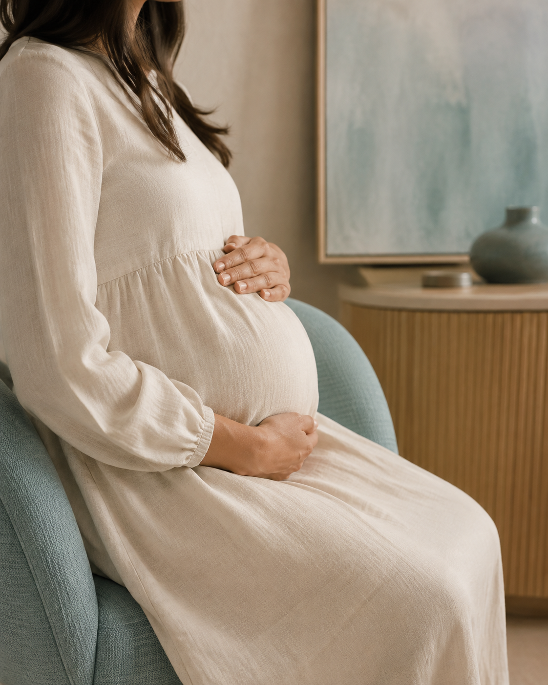 An expectant mother resting her hands gently on her belly